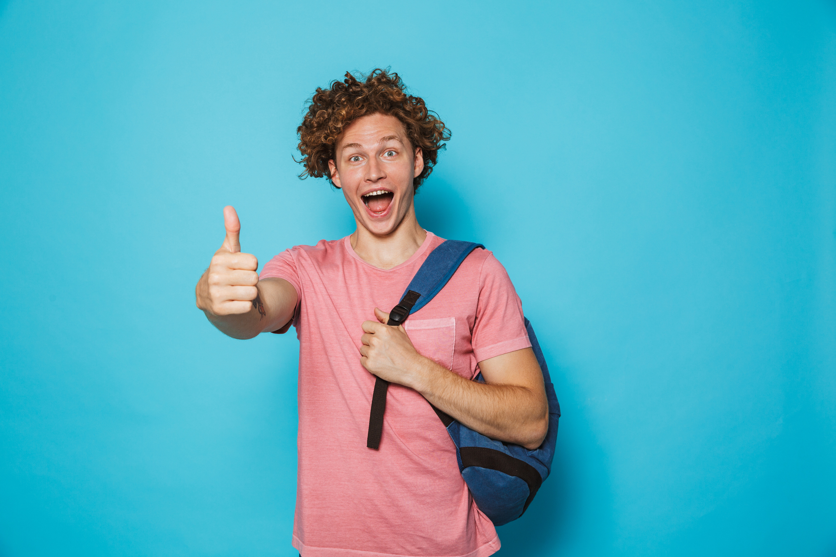Photo of Student Guy with Curly Hair Wearing Casual Clothing and